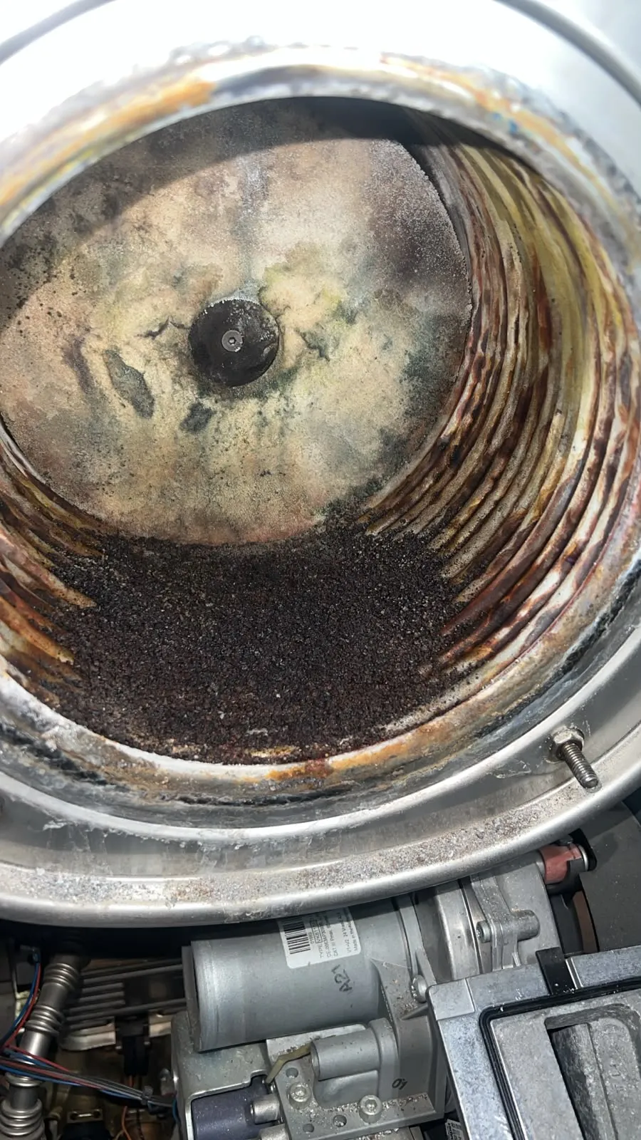 Sooted hot water cylinder before replacement