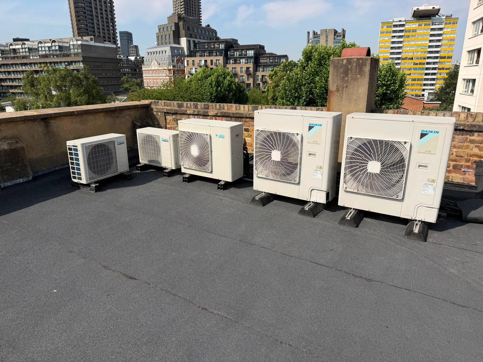 Bank of refrigeration condenser units on a flat commercial roof